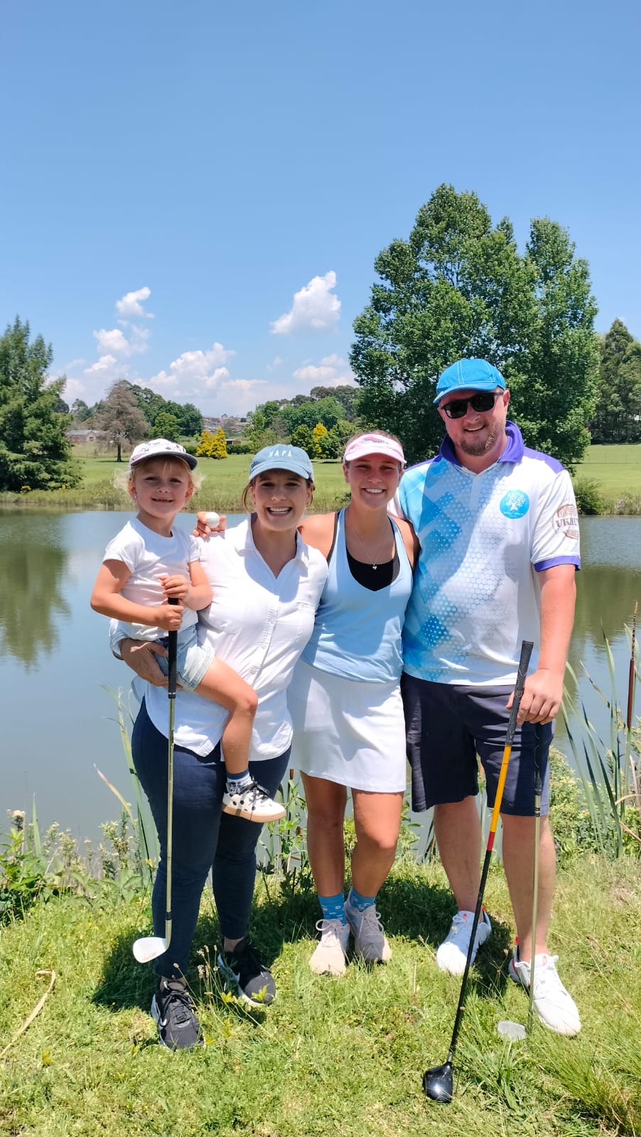 Family enjoying the grounds by the estate dam